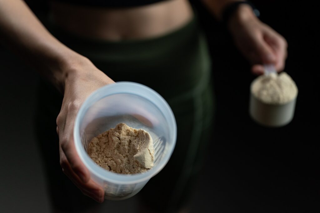 woman holding protein powder for weight loss